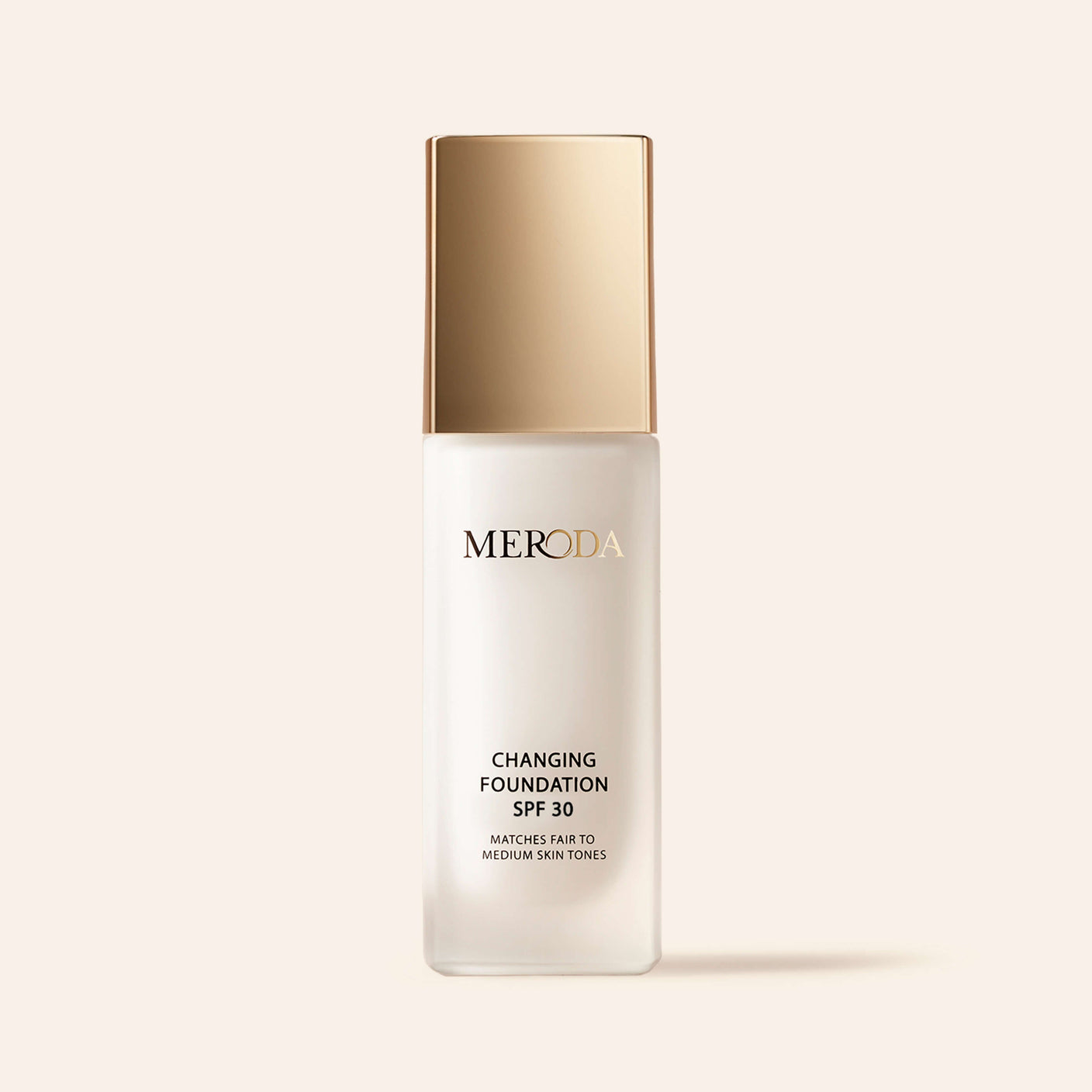 Meroda Changing Foundation SPF 30 bottle with a gold cap for fair to medium skin tones on a light background.