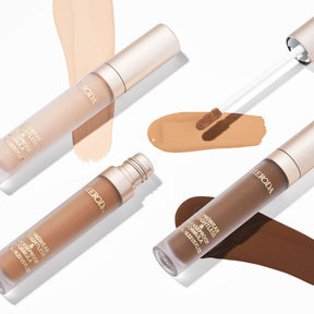 Meroda Cosmetics Universal Concealer in three shades with hydrating swatches and a wand applicator for a natural finish.