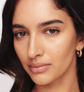 Gilded Lashes Mascara on model showing lengthened, volumized, and defined lashes for a natural finish.
