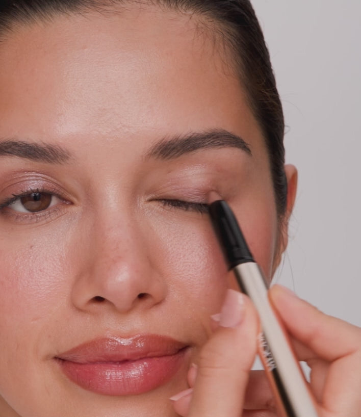 Eye Perfecting Shimmer Stick applied to eyelids and blended with a finger for a radiant, glowing finish.