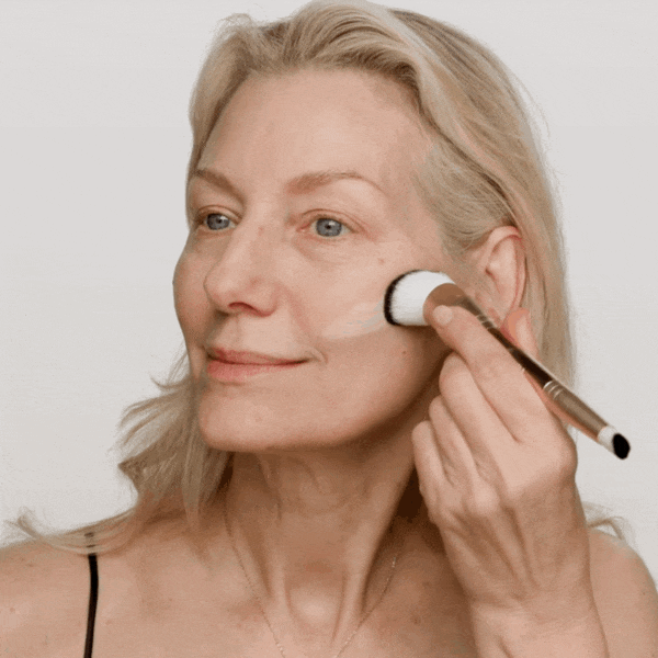Meroda Cosmetics All-in-One Bundle showing Changing Foundation application with a brush for a seamless finish.