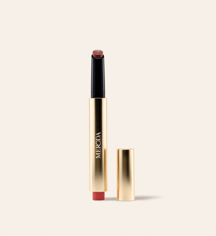 Hydrating Lip Tint in Rich Berries featuring a gold metallic click pen with its detached cap against a light background.