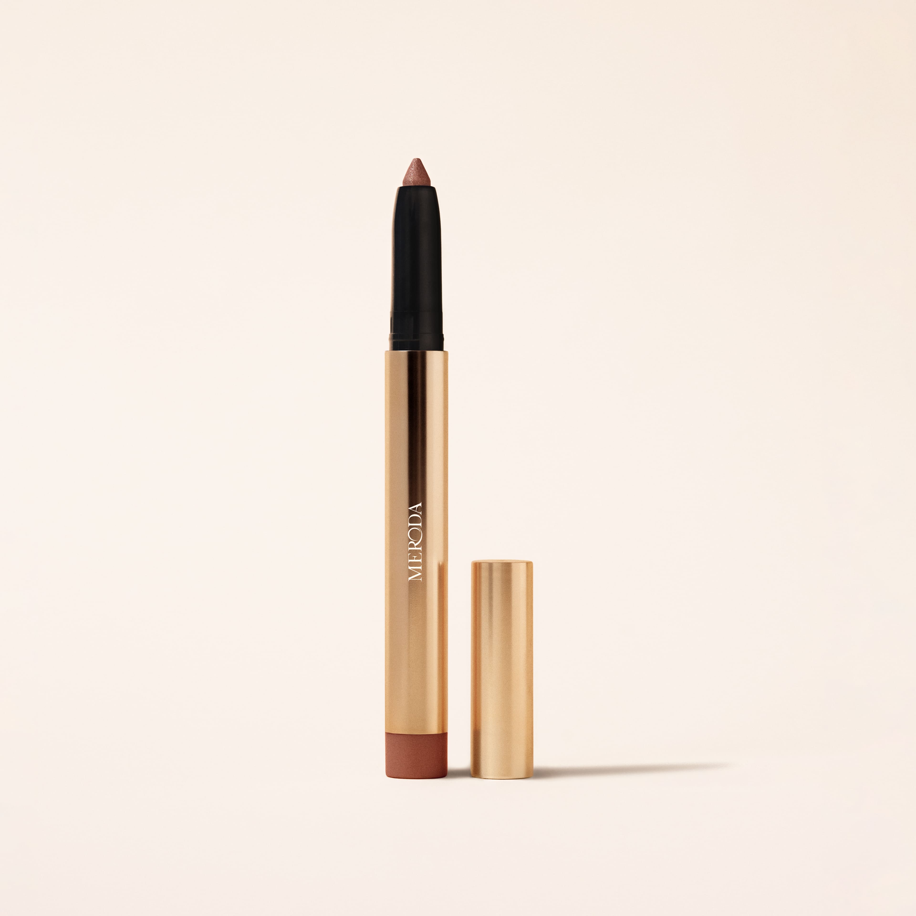Meroda Cosmetics Eye Perfecting Shimmer Stick in Mauve featuring a shimmering tip and sleek gold metallic packaging.
