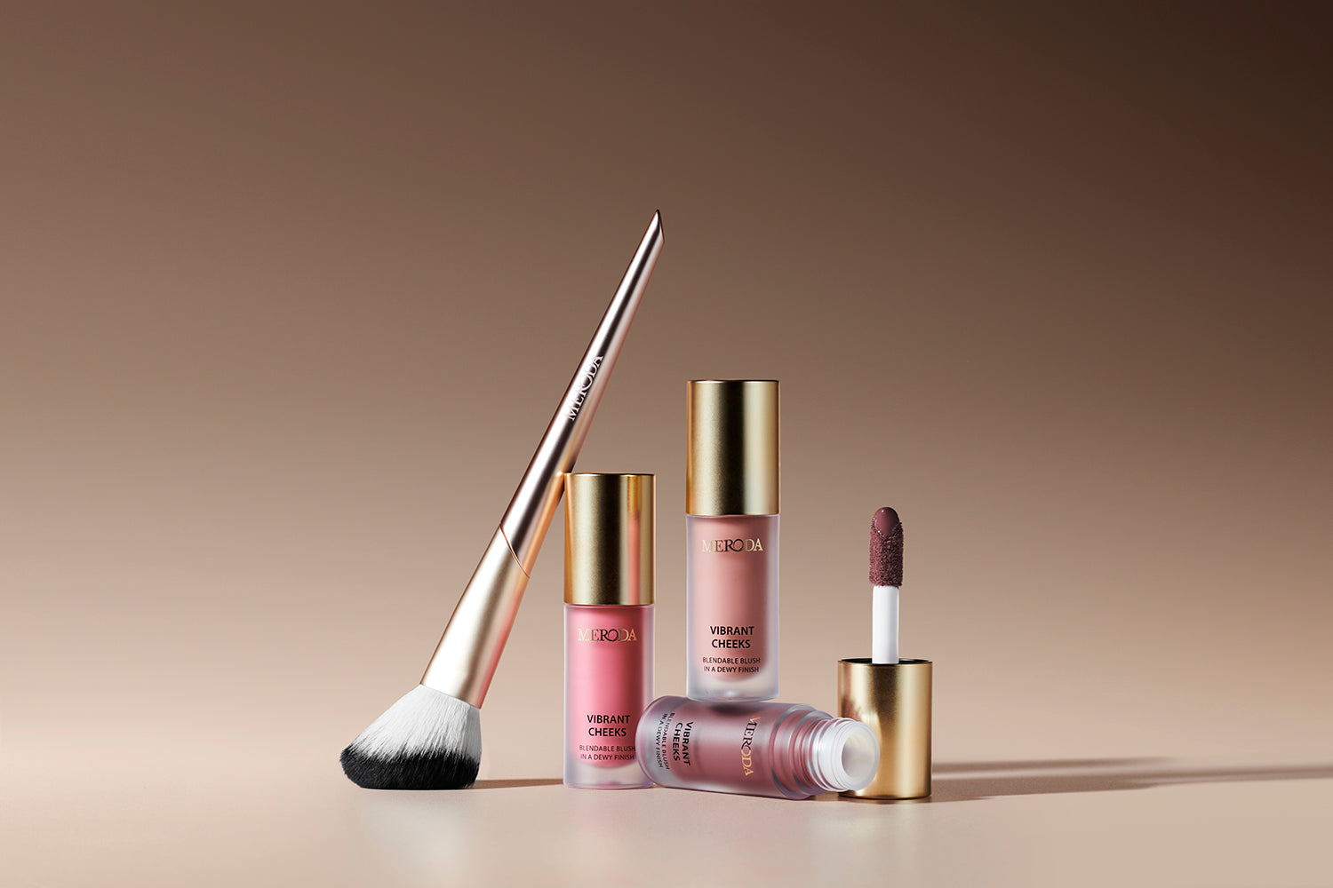 Meroda Vibrant Cheeks Blush Brush with gold handle, Vibrant Cheeks Liquid Blush bottles and applicator wand