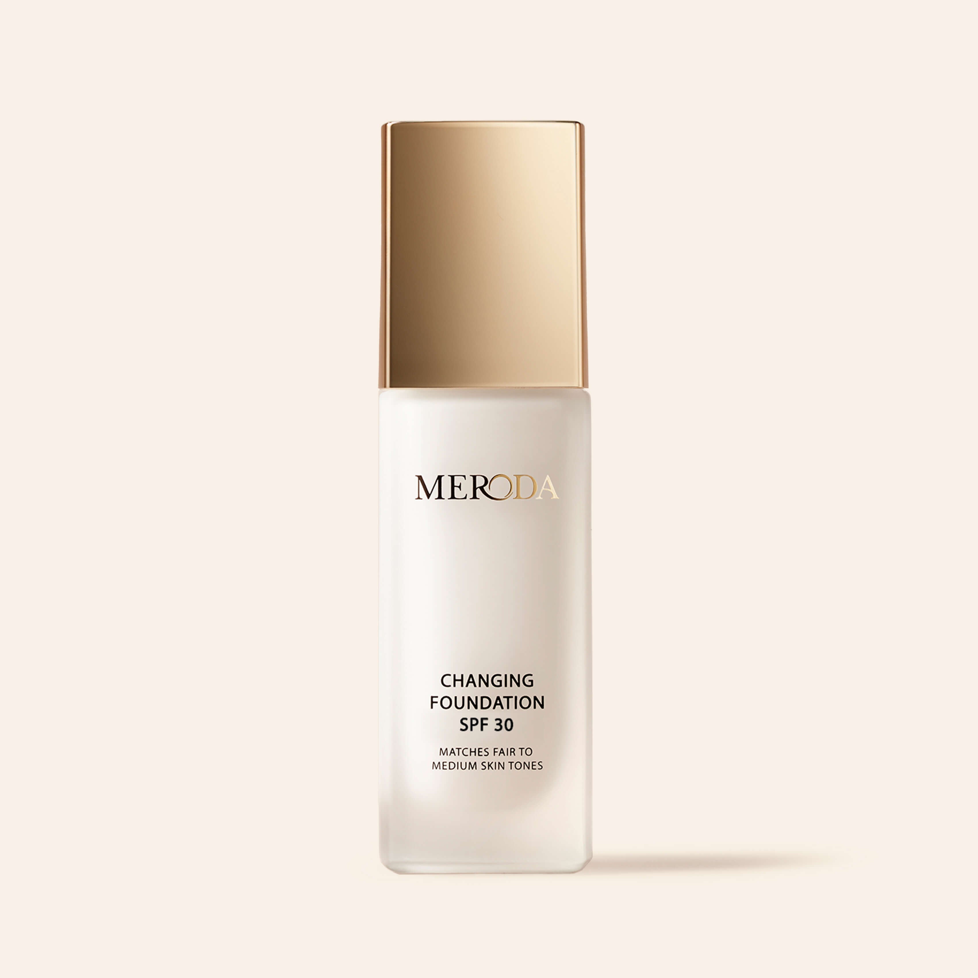 Meroda Changing Foundation SPF 30 bottle with a gold cap for fair to medium skin tones on a light background.