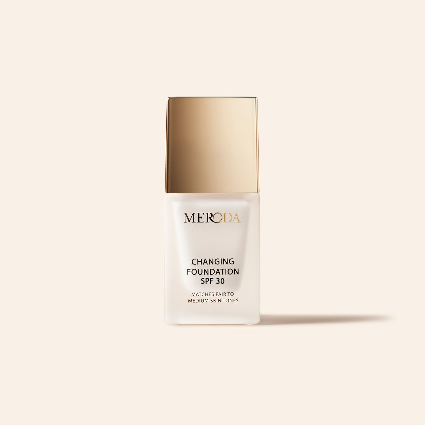 Meroda Cosmetics Mini Changing Foundation SPF 30 in a frosted bottle with a gold cap for fair to medium skin tones.