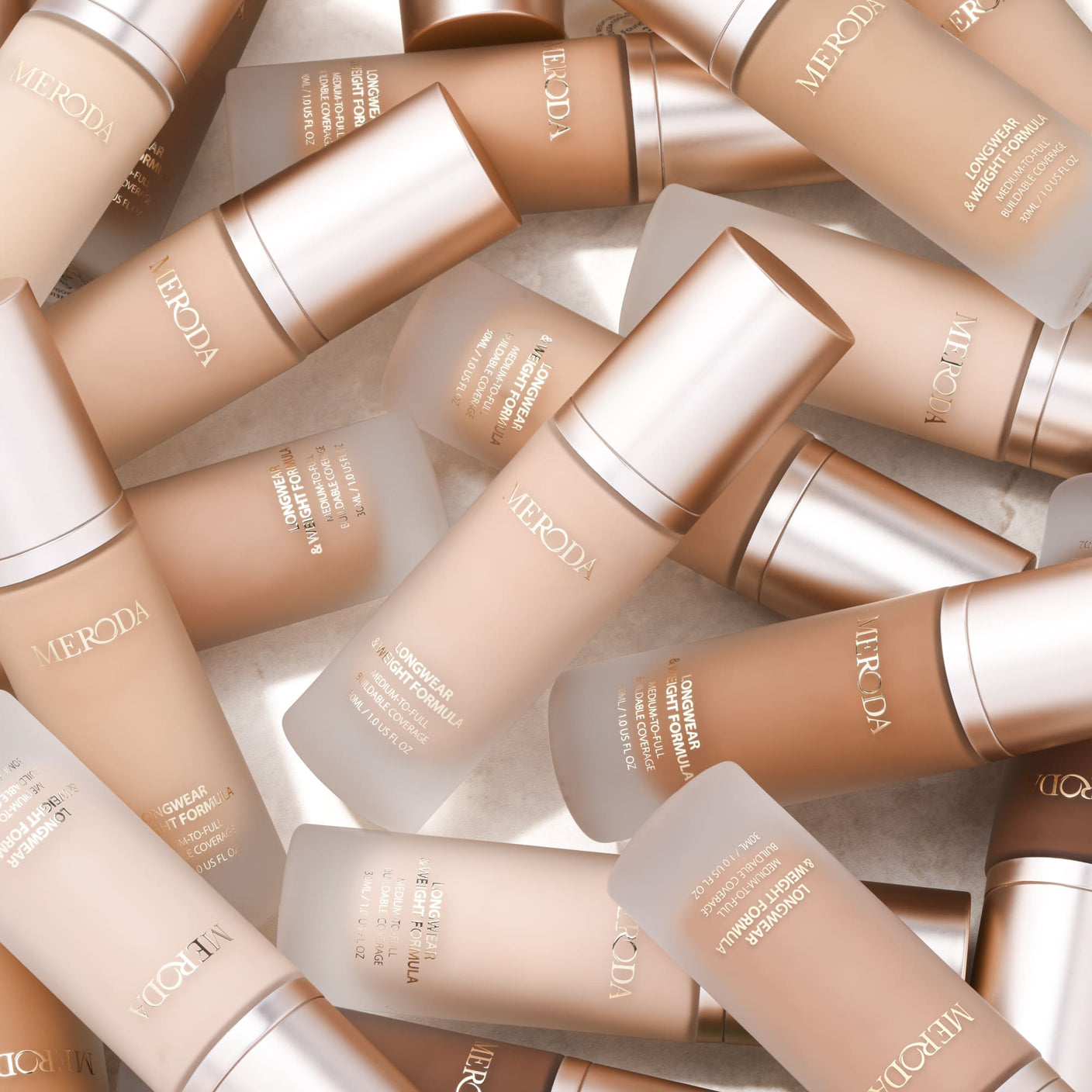 Meroda Universal Foundation in various shades with frosted glass bottles and rose gold caps for a natural matte finish.