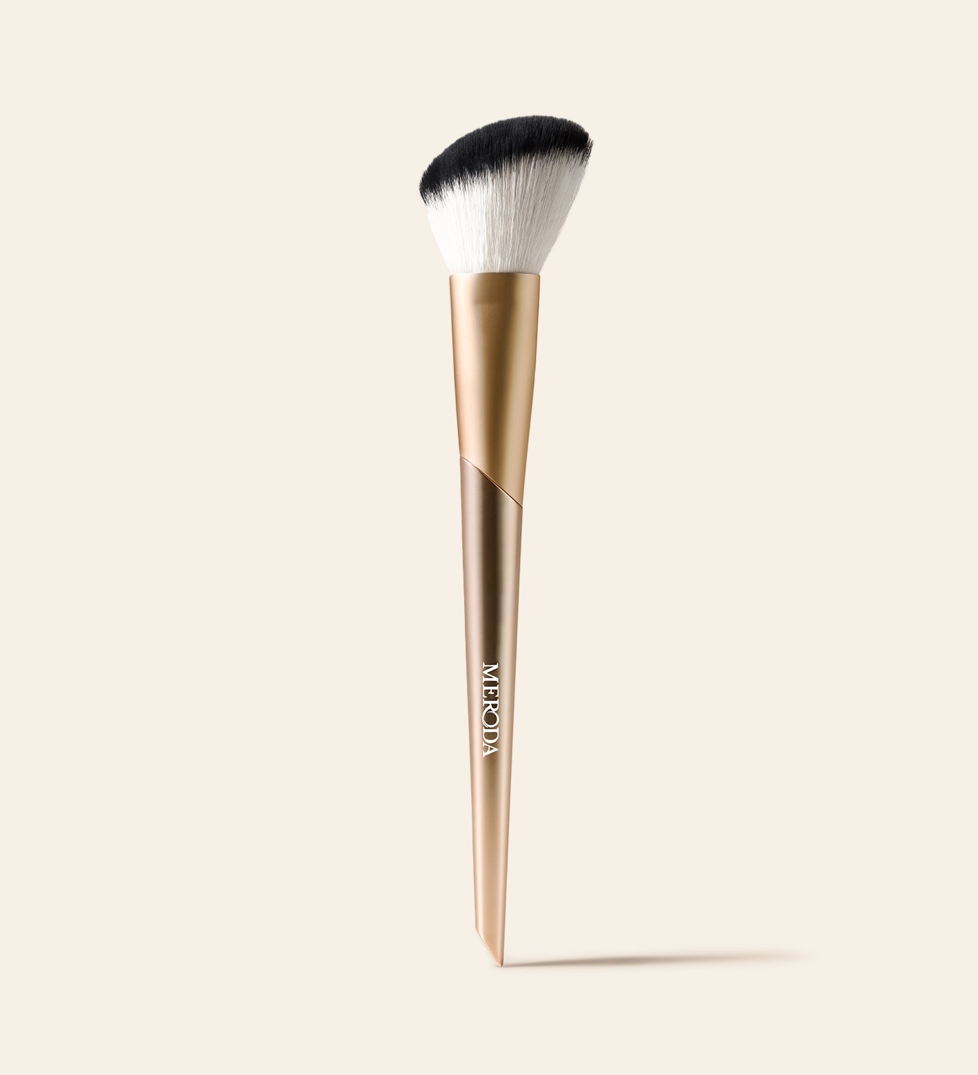 Meroda Cosmetics Vibrant Cheeks Blush Brush with soft angled synthetic bristles and a gold handle for a seamless finish
