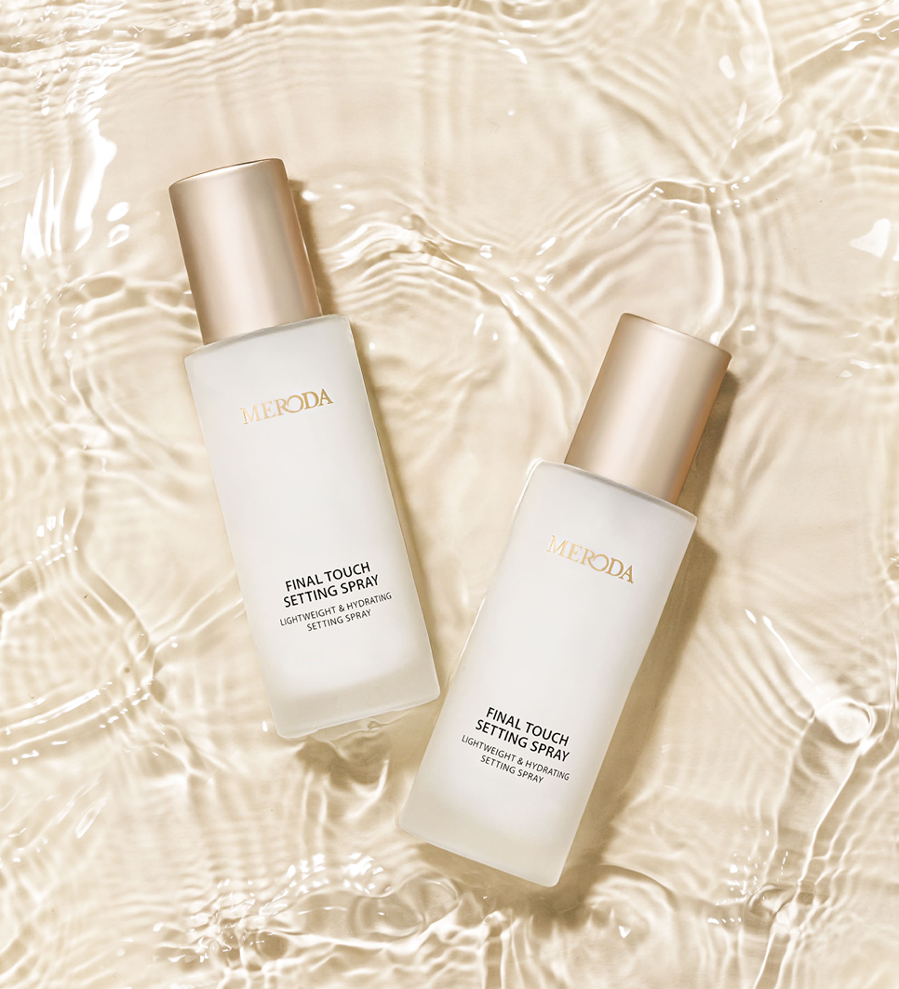 Meroda Cosmetics Final Touch Setting Spray bottles in clear rippling water, showcasing the hydrating and refreshing formula