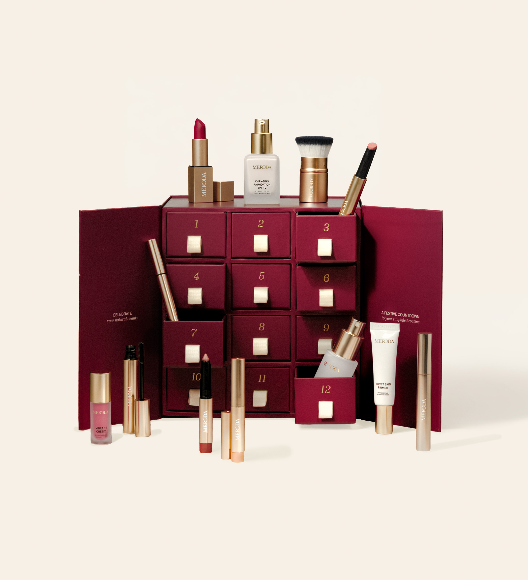 Advent Calendar - 12 Days of Effortless Beauty featuring a burgundy box with drawers and assorted makeup products displayed on cream.